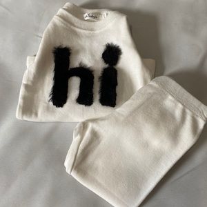 Black and white long sleeve shirt with white pants